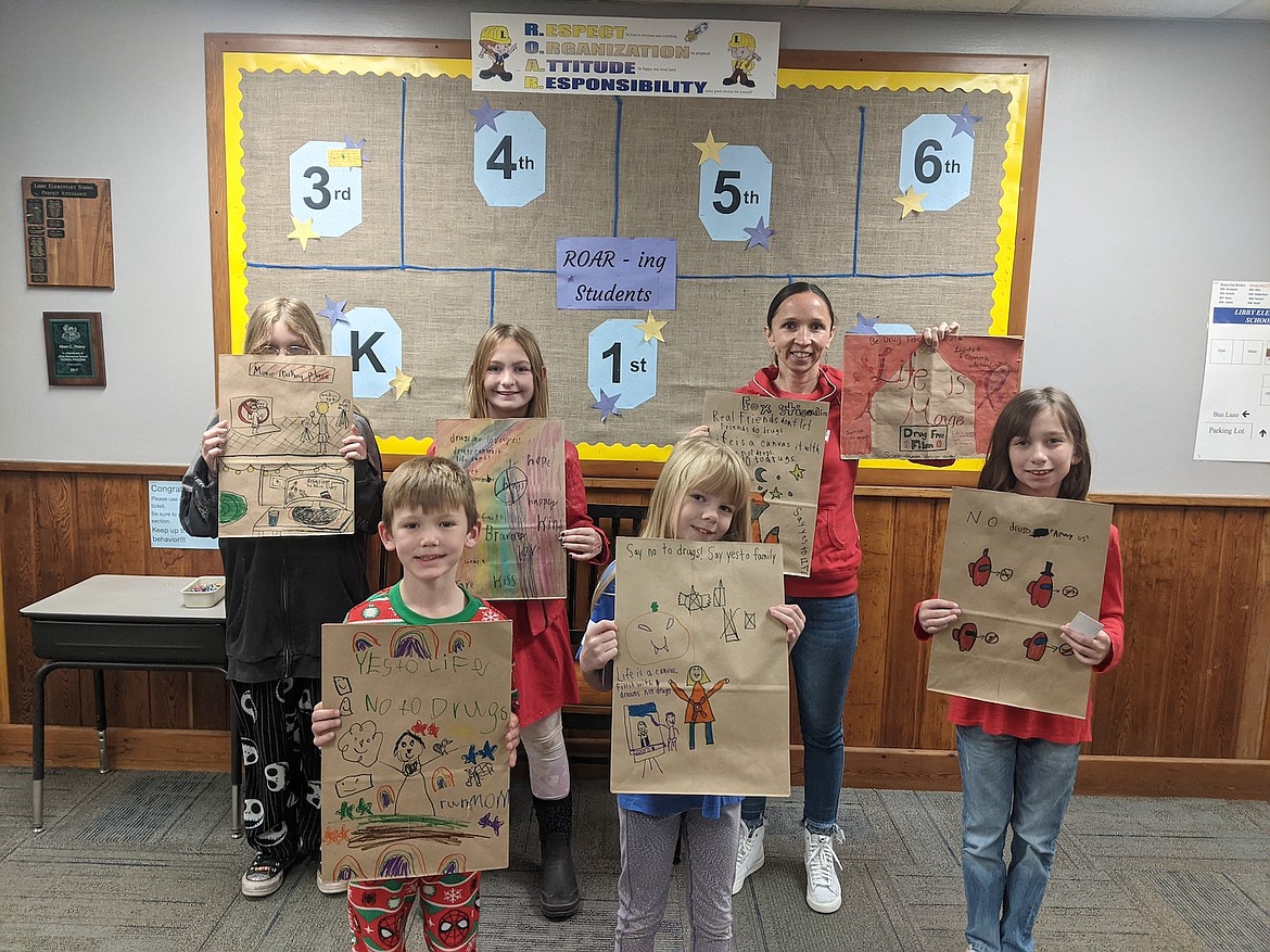 Here are the Libby Elementary School Red Ribbon Week paper bag contest winners. From left, front row, are George Berschneider, Kallista James and Aspen Etcheverry. From left, back row, are Hailey Williamson, Khori Skeers, and Dr. Katzer holding absent winners' paper bags (Faith Riley and Quinn Fantozzi). (Courtesy photo)
