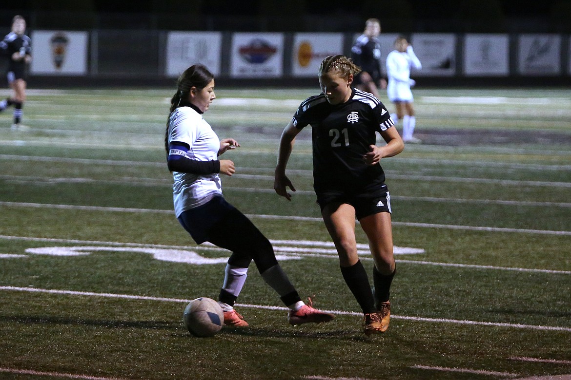 Royal freshman Hali Christensen keeps her eye on the ball while being defended by a Kiona-Benton player on Oct. 29.