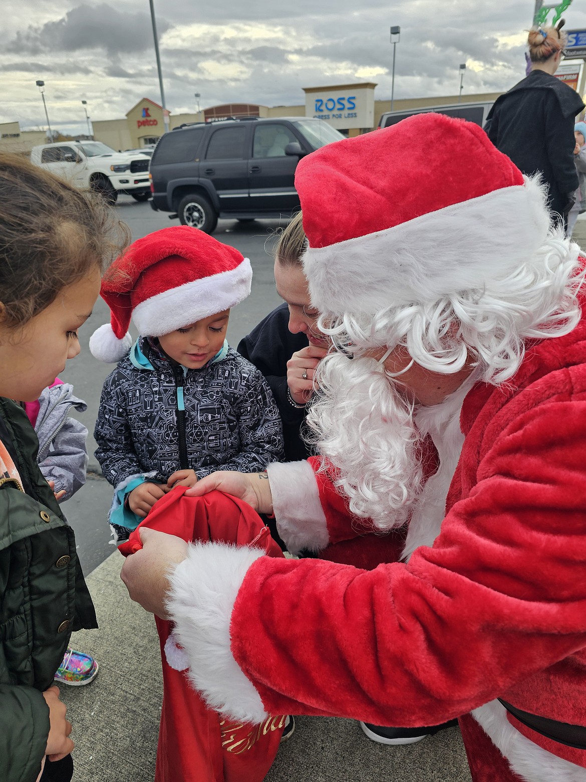 DJ Sweet, in his role as Santa, visits with kids at the Moms Helping Moms toy drive last weekend. The next drive will be Dec. 7-8, with Andy Blauert donning the red suit.