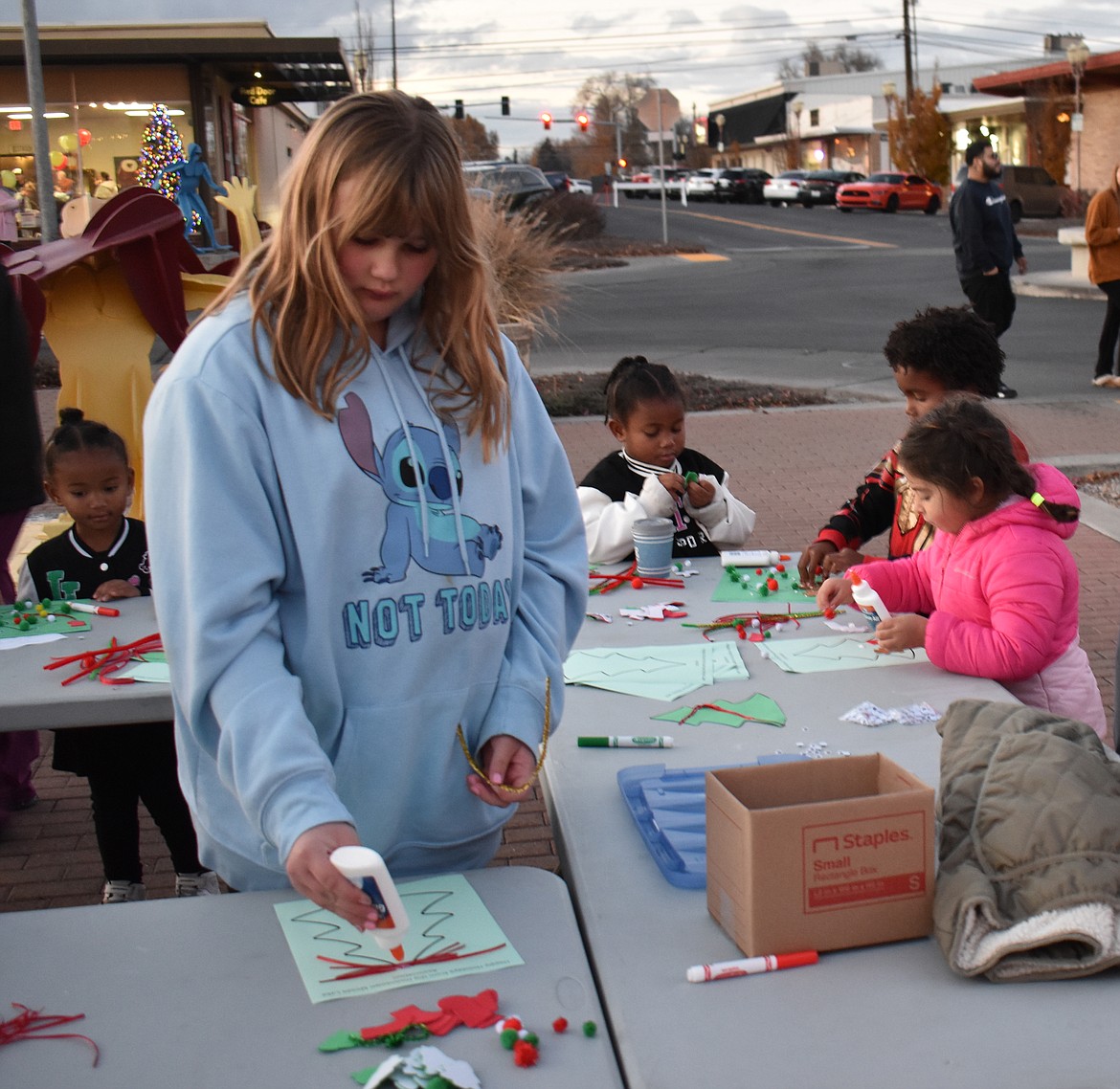 Craft tables were set out at the Moses Lake tree lighting Friday night, where kids of all ages could decorate their own paper Christmas trees.