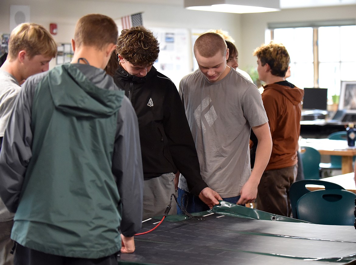 AP Environmental Science students examine one of NUE's solar panels last week. (Julie Engler/Whitefish Pilot)