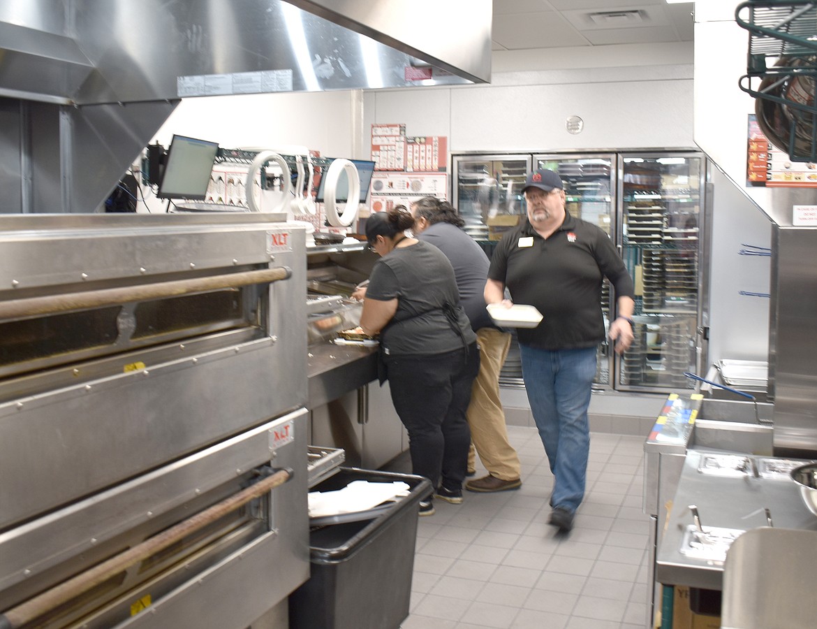 The crew at Othello’s Pizza Hut kicked into action at the store’s opening day Tuesday morning. The store employs 23 people and will probably add a couple more, said General Manager David Beaty.