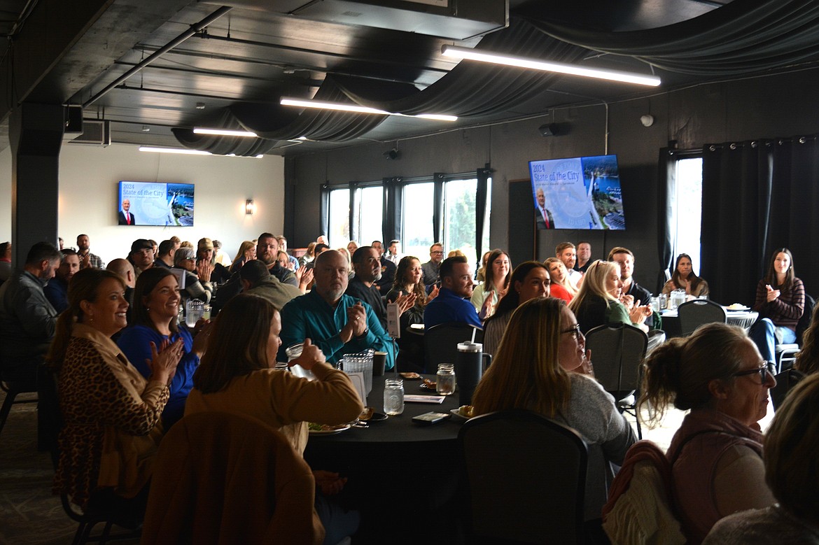 The crowd applauds Mayor Ron Jacobson during the Post Falls Chamber of Commerce State of the City address Tuesday at Prairie Falls Golf Club.