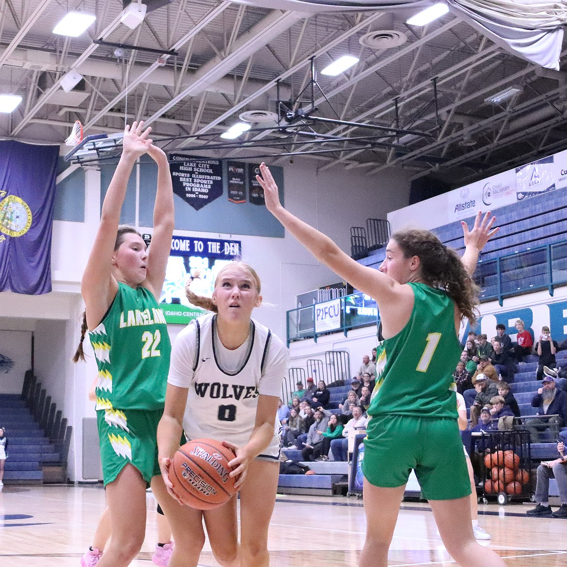 Photo by JERRY VICK
Lake City sophomore guard Macy Murphey splits the defense of Lakeland's Jersi McMurray (22) and Karstyn Kiefer (1) during Tuesday's game at Lake City High.