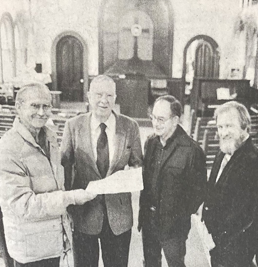 In 1984, the Museum of North Idaho receives the deed to the Fort Sherman Chapel from the Athletic Round Table. Pictured from left: museum president Jack Pierce, R.J. McDonald of ART, museum director Gard Teall and Rev. Charles Hancock, whose Unity Church used the building.