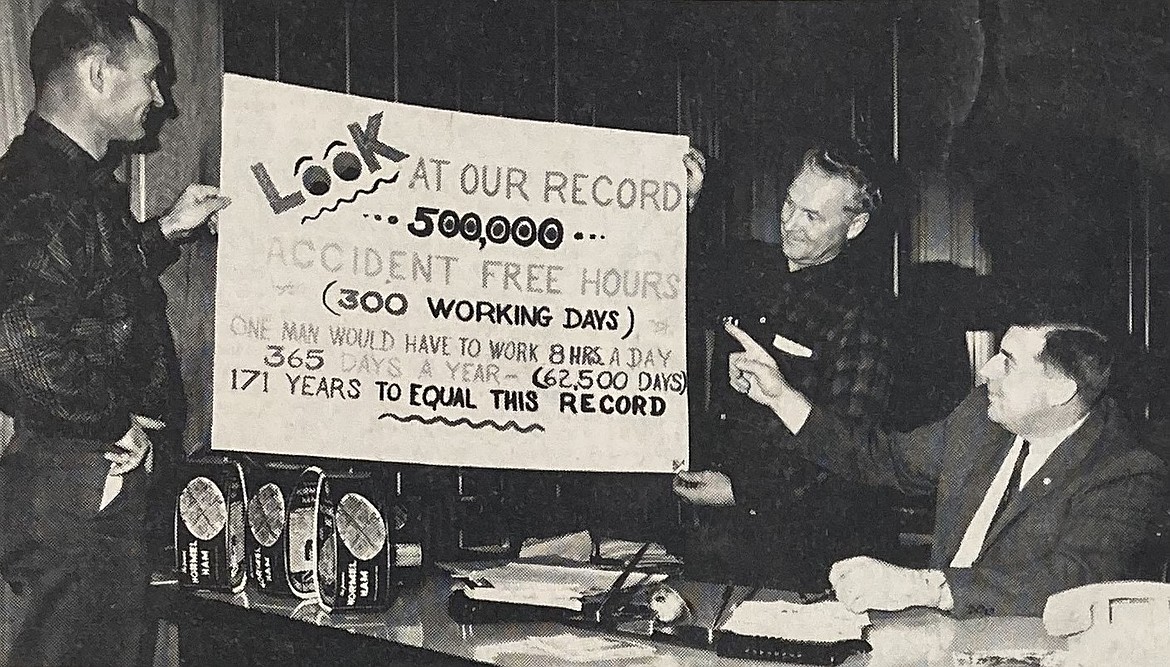 In 1964, safety director Gene Jolin, of Potlatch’s Rutledge mill, left, and plant manager Roger C. Carlson, seated, look at Don Smith’s safety chart.