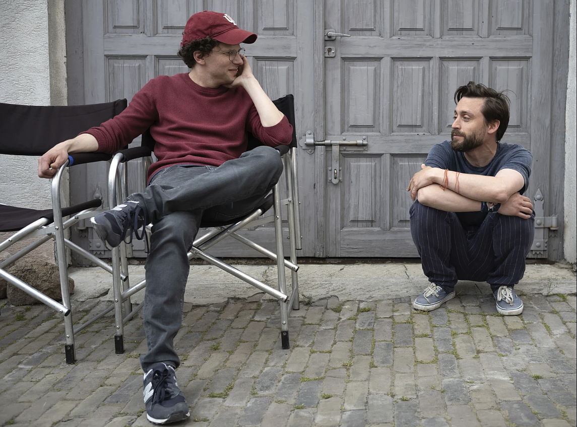 This image released by Searchlight Pictures shows Kieran Culkin, right, and Jesse Eisenberg on the set of "A Real Pain."