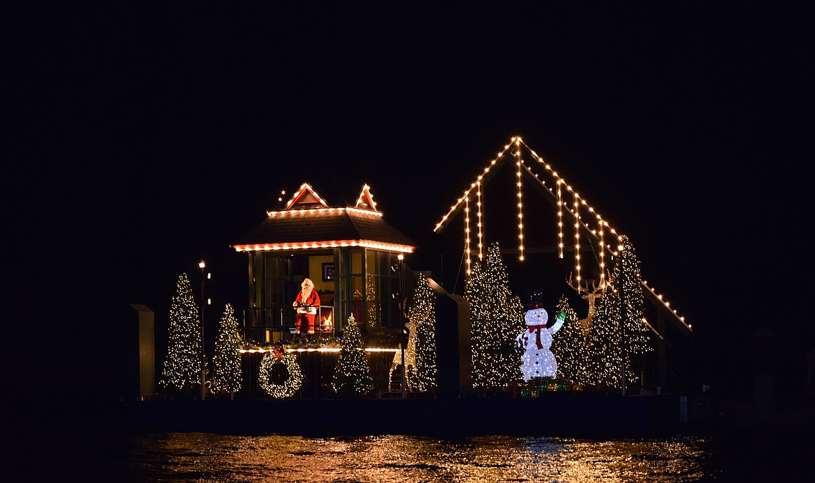 Santa Claus welcomes families and children to the North Pole from his deck Tuesday night.