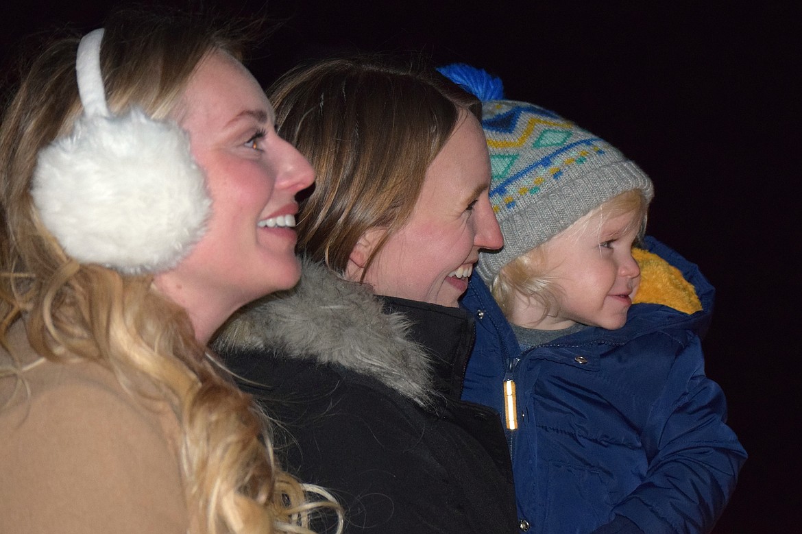 Alexis Culnane (left), Kiana Tompke (right) and Camden, 2, were all smiles watching the lights and fireworks over Lake Coeur d'Alene on Tuesday night.