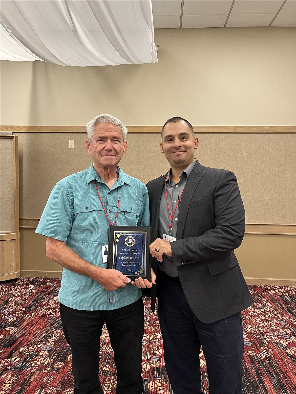 Clif Warren accepts his Hall of Fame Transportation Champion award from Idaho Public Transportation Manager Ron Duran.