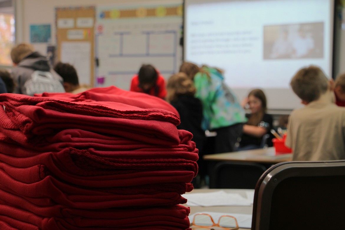 Second and fourth graders at Farmin Stidwell Elementary draft letters of kindness as part of a project that will deliver 210 fleece blankets to community members in need.