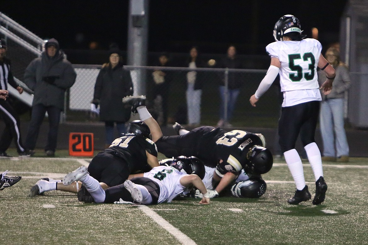 Royal defenders pounce on a loose ball during a Nov. 8 game against Klahowya. The Knights have forced 34 turnovers this season.