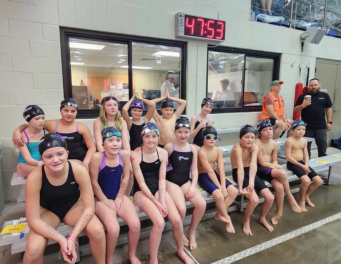 Some members of the Sandpoint Sharks swim team pose for a photo at the Adam England Memorial Fall Splash held Nov. 15-17 at the Kroc Center. Pictured, back row, from left are Elleigh Petersen, Constance Ferris, Charlie Creager, Zoey Travnicek, Isaac Good and Charlie Johnson. Bottom row, from left are Payne Coleman, Katheryn Bracht, Lillian Montgomery, Emerson Johnson, Bennett Somerville, Declan Somerville, Gabriel Hawkins and Jake Hancock.