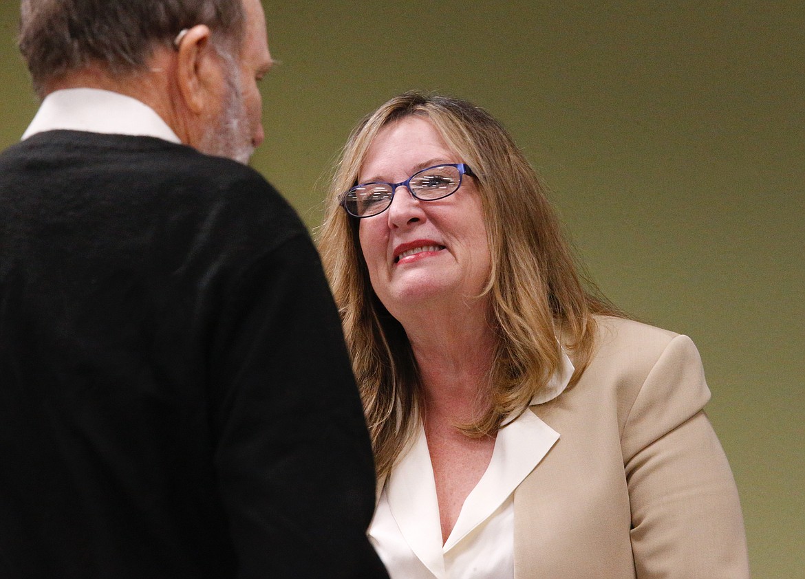 A community member confers with NIC Trustee Eve Knudtsen before a board meeting Wednesday.