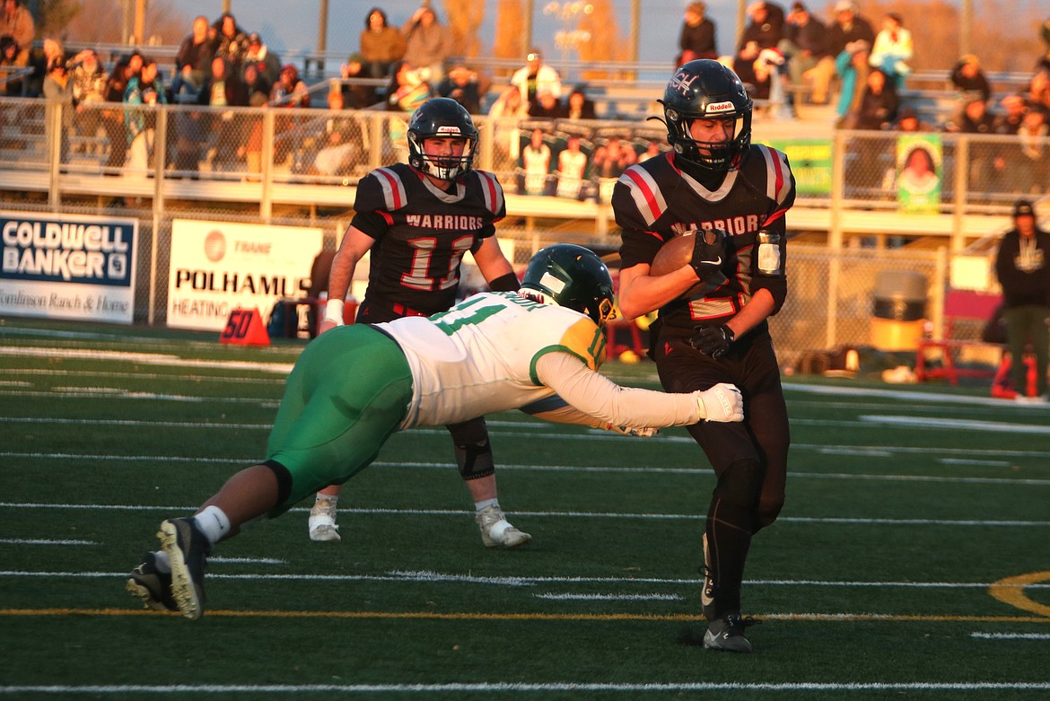 Almira/Coulee-Hartline junior Brady Roberts, right, runs toward the end zone during Friday’s game against Inchelium. Roberts scored three touchdowns in the win over the Hornets.