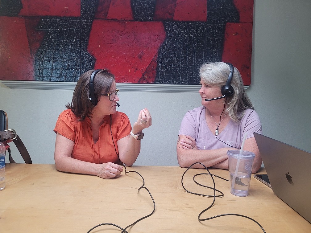 Callie Cabe, left, and Ali Shute engage in discussion before introducing their guest June 11 as they record the Ali and Callie Artcast in a studio in downtown Coeur d'Alene.