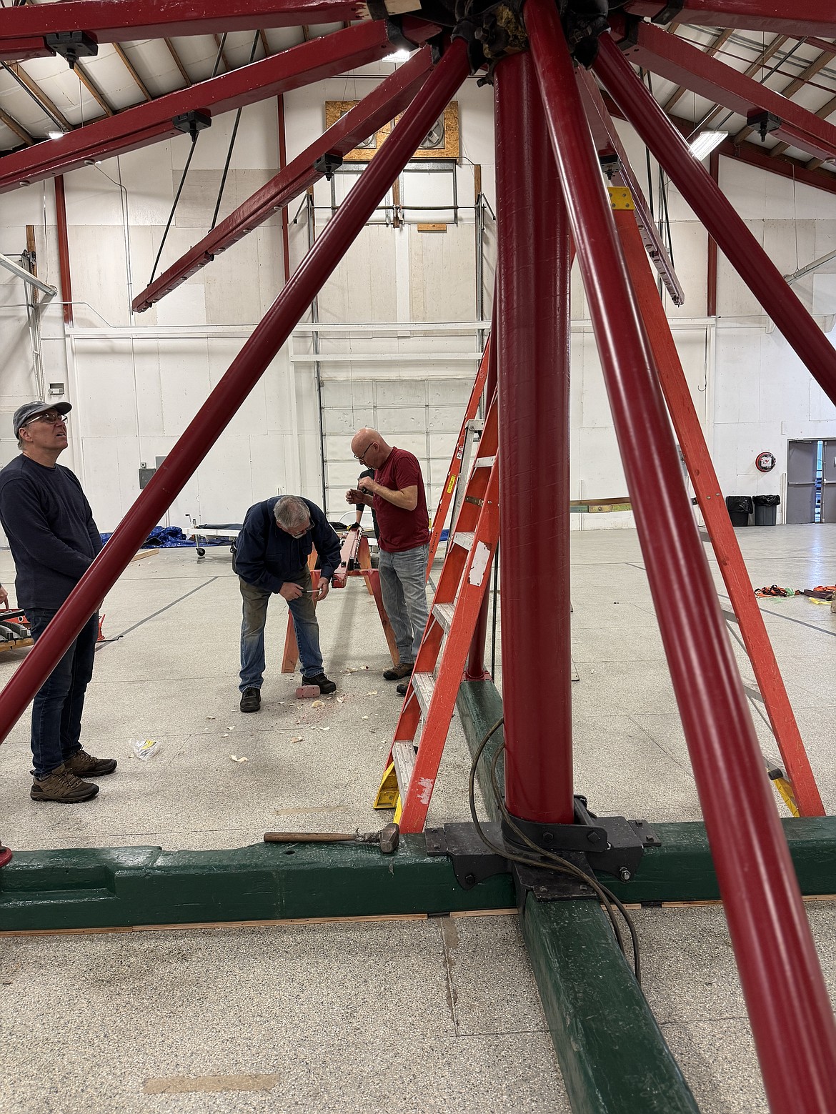 Volunteers make adjustments to the Carousel of Smiles as they work to put the Golden Age carousel together for only the second time after being purchased by Reno and Clay Hutchison. A cadre of volunteers have been working to restore the carousel since 2017.