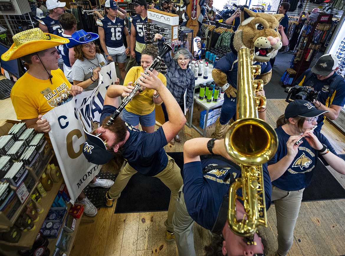 MSU President Waded Cruzado cheers on the Spirit of the West during Cat Walk, an annual stroll through downtown Bozeman and its businesses to stir up Bobcat support at the start of each academic year. (MSU photo by Colter Peterson)