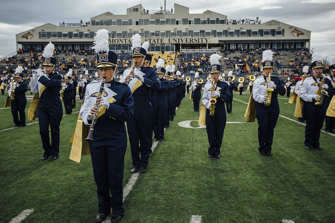 The marching band performs during halftime of a Bobcat football game. To make letters and shapes on the field, band members march precisely. Each step is 22.5 inches. (MSU photo by Adrián Sánchez-González)