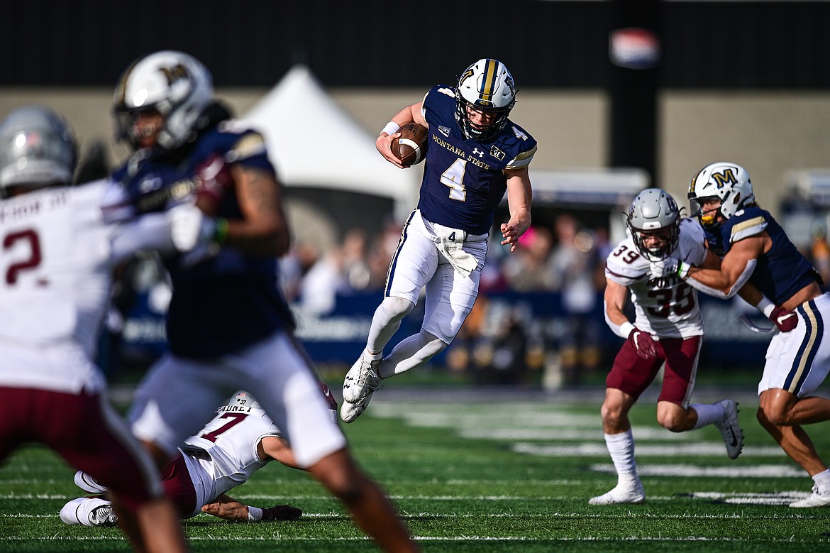 Bobcats quarterback Tommy Mellott (4) avoids a Grizzlies defender on a run in the first quarter during the 123rd Brawl of the Wild at Bobcat Stadium on Saturday, Nov. 23. (Casey Kreider/Daily Inter Lake)