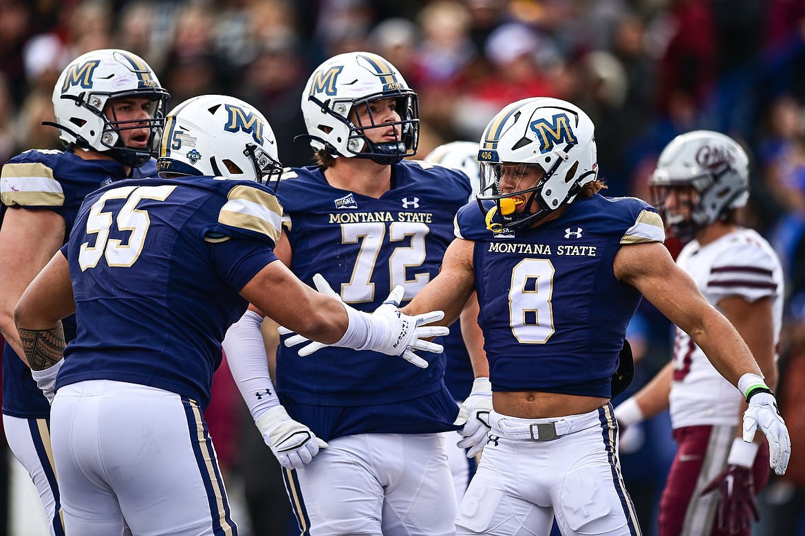 Bobcats tight end Rohan Jones (8) celebrates with teammates after a 35-yard touchdown reception in the second quarter during the 123rd Brawl of the Wild at Bobcat Stadium on Saturday, Nov. 23. (Casey Kreider/Daily Inter Lake)