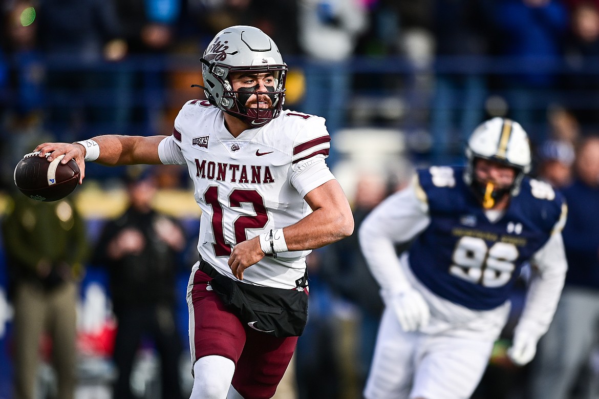 Grizzlies quarterback Logan Fife (12) rolls out to pass in the second quarter against the Bobcats during the 123rd Brawl of the Wild at Bobcat Stadium on Saturday, Nov. 23. (Casey Kreider/Daily Inter Lake)