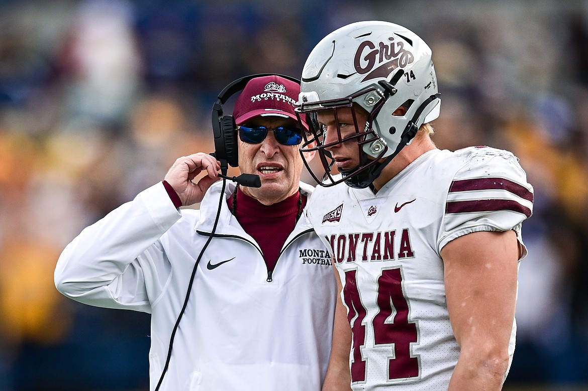 Grizzlies head coach Bobby Hauck talks over the defense with linebacker Ryan Tirrell (44) in the second quarter against the Bobcats during the 123rd Brawl of the Wild at Bobcat Stadium on Saturday, Nov. 23. (Casey Kreider/Daily Inter Lake)