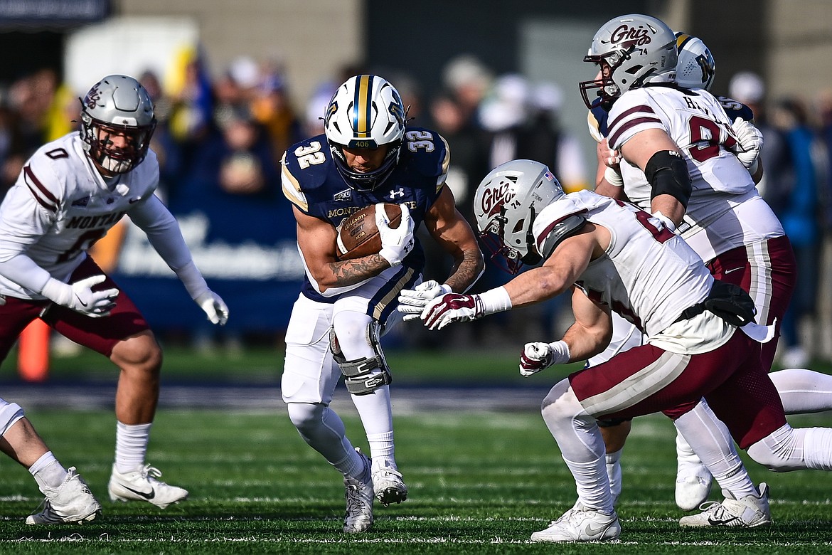 Bobcats running back Julius Davis (32) picks up yardage on a run in the first quarter against the Grizzlies during the 123rd Brawl of the Wild at Bobcat Stadium on Saturday, Nov. 23. (Casey Kreider/Daily Inter Lake)