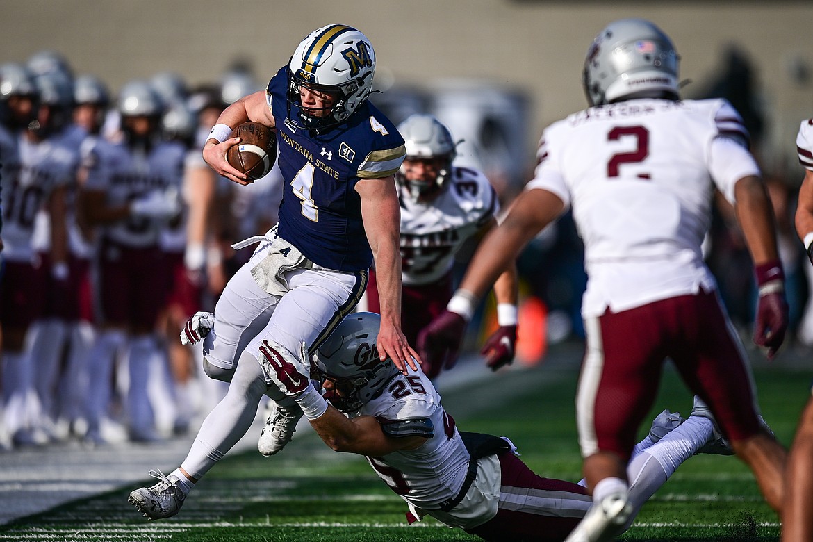 Bobcats quarterback Tommy Mellott (4) picks up yardage on a run in the first quarter against the Grizzlies during the 123rd Brawl of the Wild at Bobcat Stadium on Saturday, Nov. 23. (Casey Kreider/Daily Inter Lake)