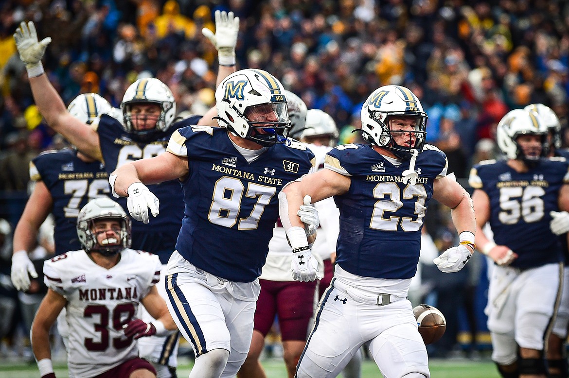 Bobcats running back Adam Jones (23) celebrates after a 2-yard touchdown run in the fourth quarter against the Grizzlies during the 123rd Brawl of the Wild at Bobcat Stadium on Saturday, Nov. 23. (Casey Kreider/Daily Inter Lake)