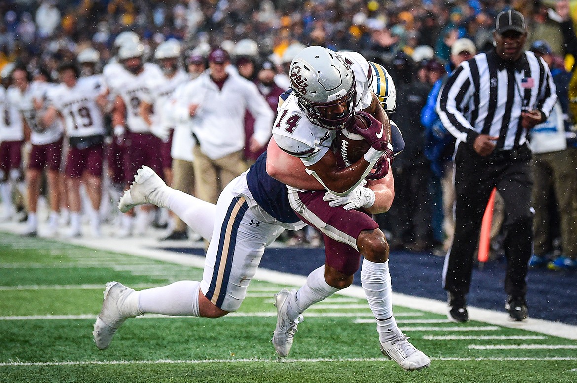 Grizzlies wide receiver Aaron Fontes (14) is brought down by Bobcats defensive end Kenneth Eiden IV (11) on a reception in the fourth quarter during the 123rd Brawl of the Wild at Bobcat Stadium on Saturday, Nov. 23. (Casey Kreider/Daily Inter Lake)