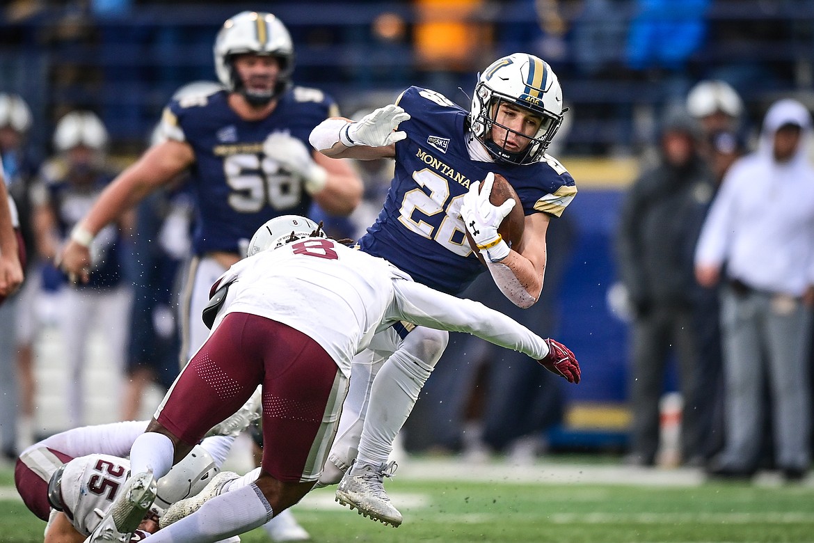 Bobcats running back Colson Coon (28) picks up yardage on a run in the fourth quarter against the Grizzlies during the 123rd Brawl of the Wild at Bobcat Stadium on Saturday, Nov. 23. (Casey Kreider/Daily Inter Lake)