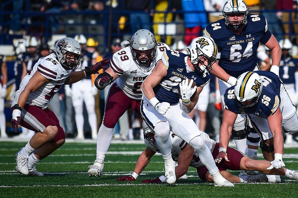 Bobcats running back Adam Jones (23) picks up yardage on a run in the first quarter against the Grizzlies during the 123rd Brawl of the Wild at Bobcat Stadium on Saturday, Nov. 23. (Casey Kreider/Daily Inter Lake)