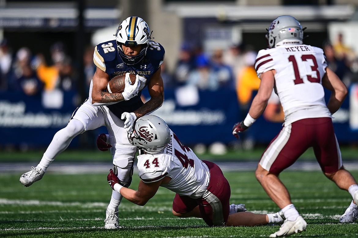 Bobcats running back Julius Davis (32) picks up yardage on a run in the first quarter against the Grizzlies during the 123rd Brawl of the Wild at Bobcat Stadium on Saturday, Nov. 23. (Casey Kreider/Daily Inter Lake)