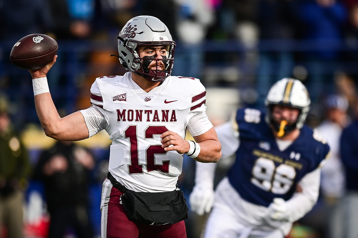 Grizzlies quarterback Logan Fife (12) rolls out to pass in the second quarter against the Bobcats during the 123rd Brawl of the Wild at Bobcat Stadium on Saturday, Nov. 23. (Casey Kreider/Daily Inter Lake)