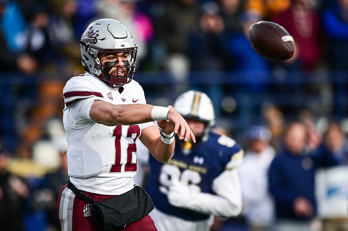 Grizzlies quarterback Logan Fife (12) rolls out to pass in the second quarter against the Bobcats during the 123rd Brawl of the Wild at Bobcat Stadium on Saturday, Nov. 23. (Casey Kreider/Daily Inter Lake)