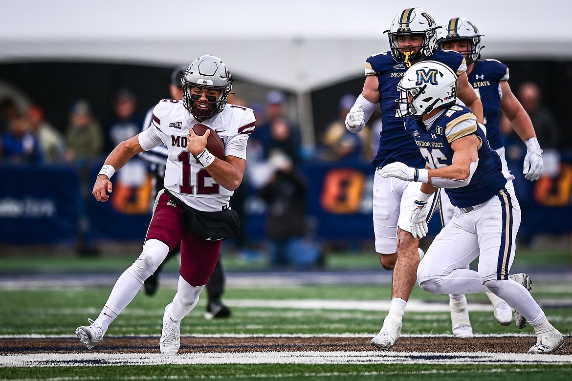 Grizzlies quarterback Logan Fife (12) picks up yardage on a run in the third quarter against the Bobcats during the 123rd Brawl of the Wild at Bobcat Stadium on Saturday, Nov. 23. (Casey Kreider/Daily Inter Lake)