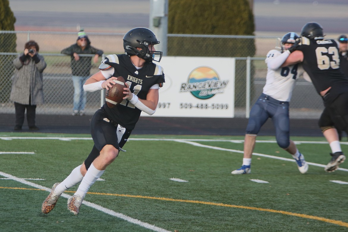 Royal senior Lance Allred (11) rolls out of the pocket before throwing an 80-yard touchdown pass in the second quarter of Saturday’s win over Lynden Christian.