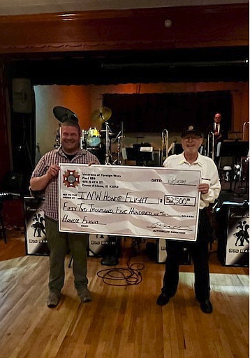 Tony Lamanna and Joe Deacon hold up the check from A Big Band Tribute to Inland Northwest Honor Flight. The fundraiser exceeded the goal of $50,000 to raise $62,500 for Honor Flight to send veterans to Washington, D.C., to be honored with other veterans. Because of the fundraiser's success, Honor Flight will be able to send about 33 veterans in 2025 with all expenses paid.