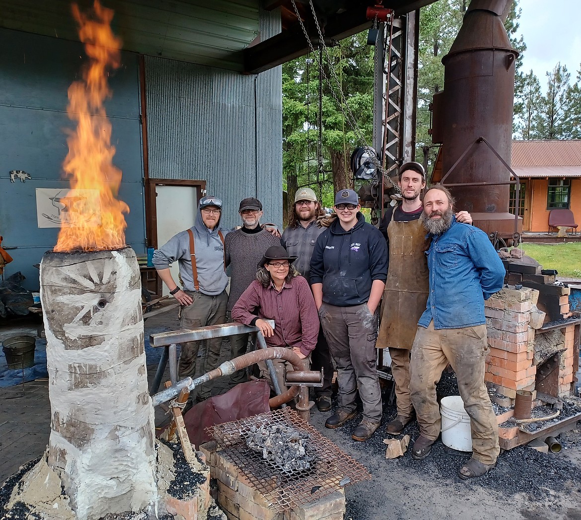 Students taking a June iron smelting class from the New Agrarian School in Bigfork pose for a class photo by a bloomery furnace. The class made iron from a variety of ores sourced in Montana and Utah. (Photo provided by Jefferey Funk)