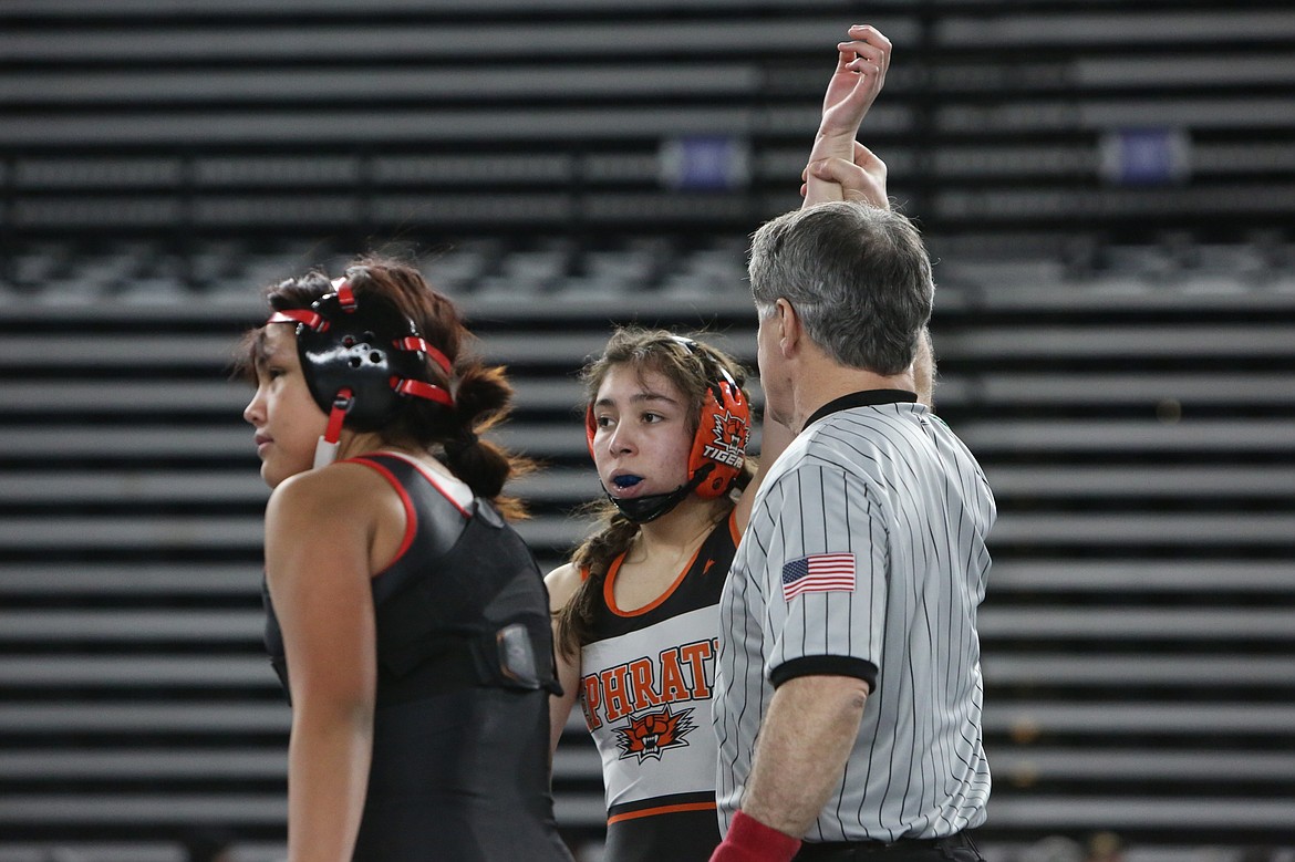 Ephrata’s Adylene Sanchez, middle, wins a match at the 2024 Mat Classic in Tacoma. Sanchez is one of two Tigers returning with state experience this season.