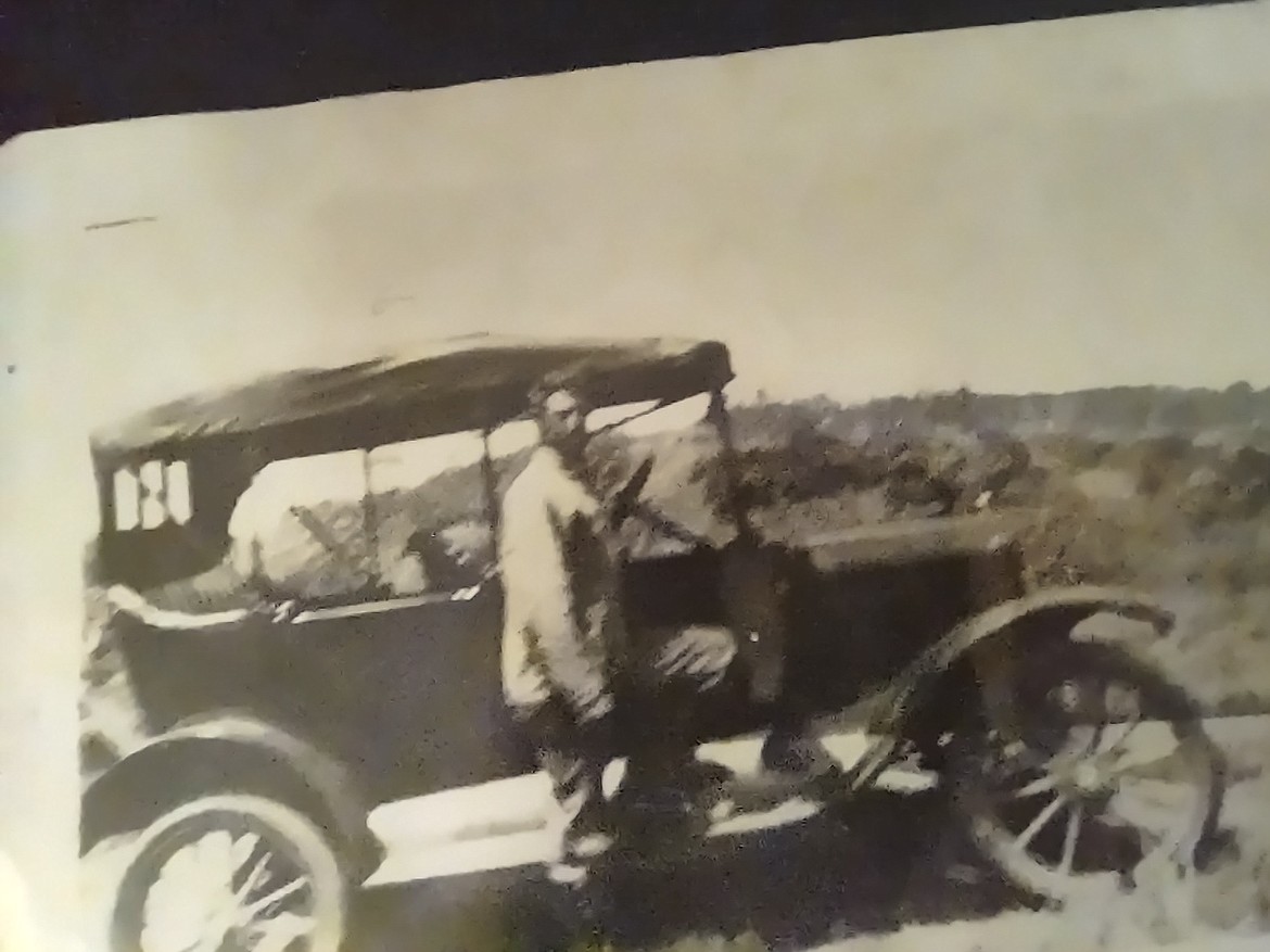 Geneva Scott’s dad standing in front of the vehicle the family used to ride over in from Oklahoma during the 1920’s. The family moved to Gold Bar, Washington before Scott met her husband of 75 years and moved to Moses Lake.