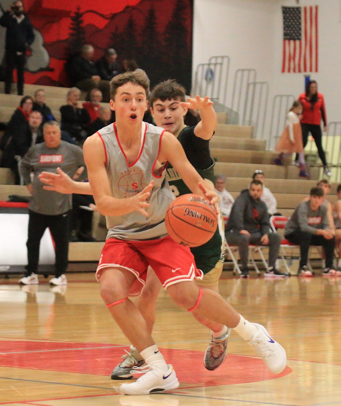 Sandpoint High sophomore Logan Iverson fakes a pass, eventually dribbling by another defender and scoring against St. Maries on Monday.