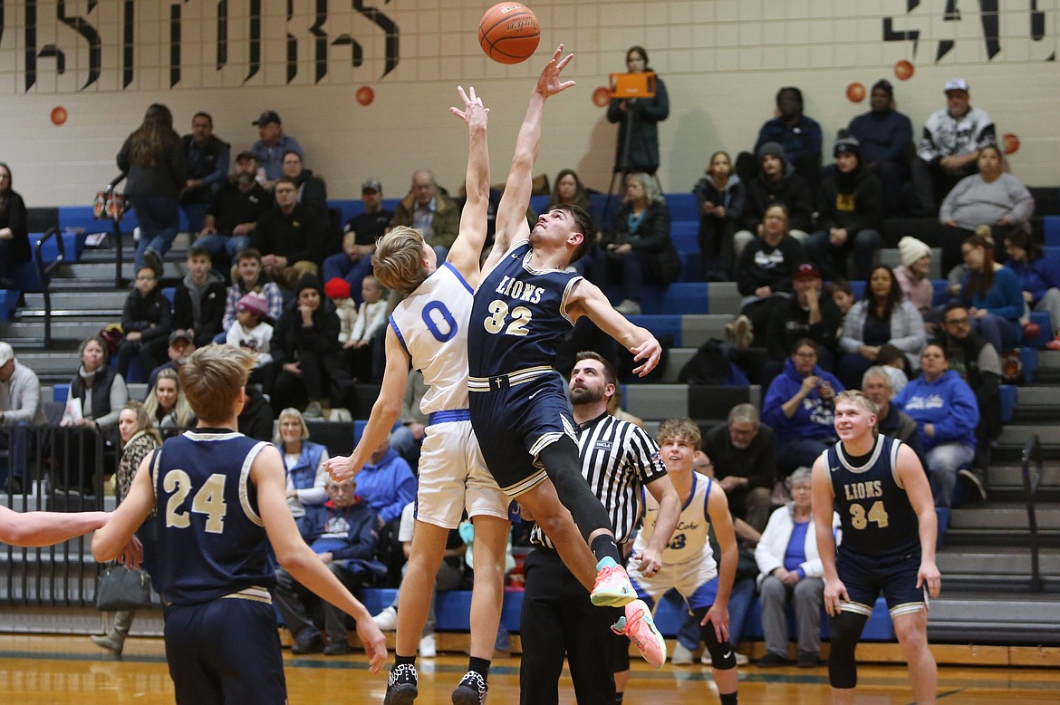 MLCA/CCS junior Dennis Gulenko (32) leaps up to grab the opening tip during a game against Soap Lake last season.