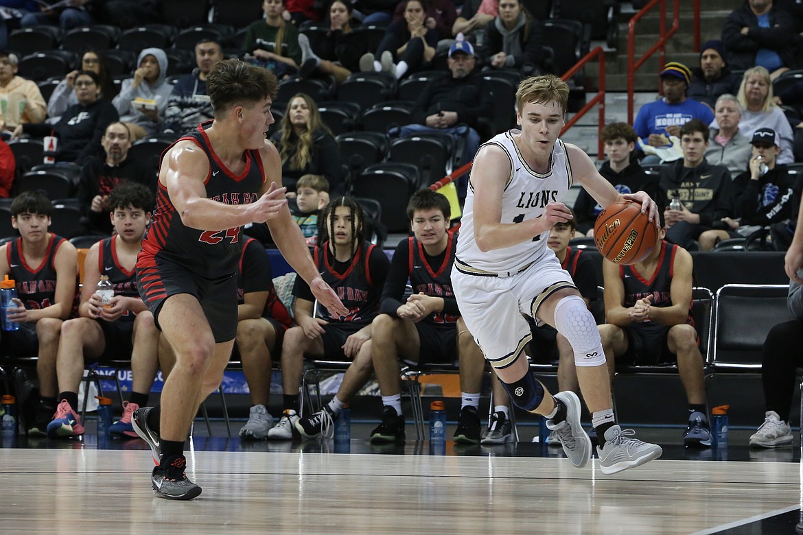 MLCA/CCS junior James Robertson, right, keeps his eyes on the baseline while moving toward the basket during a game against Neah Bay at last year’s state tournament.