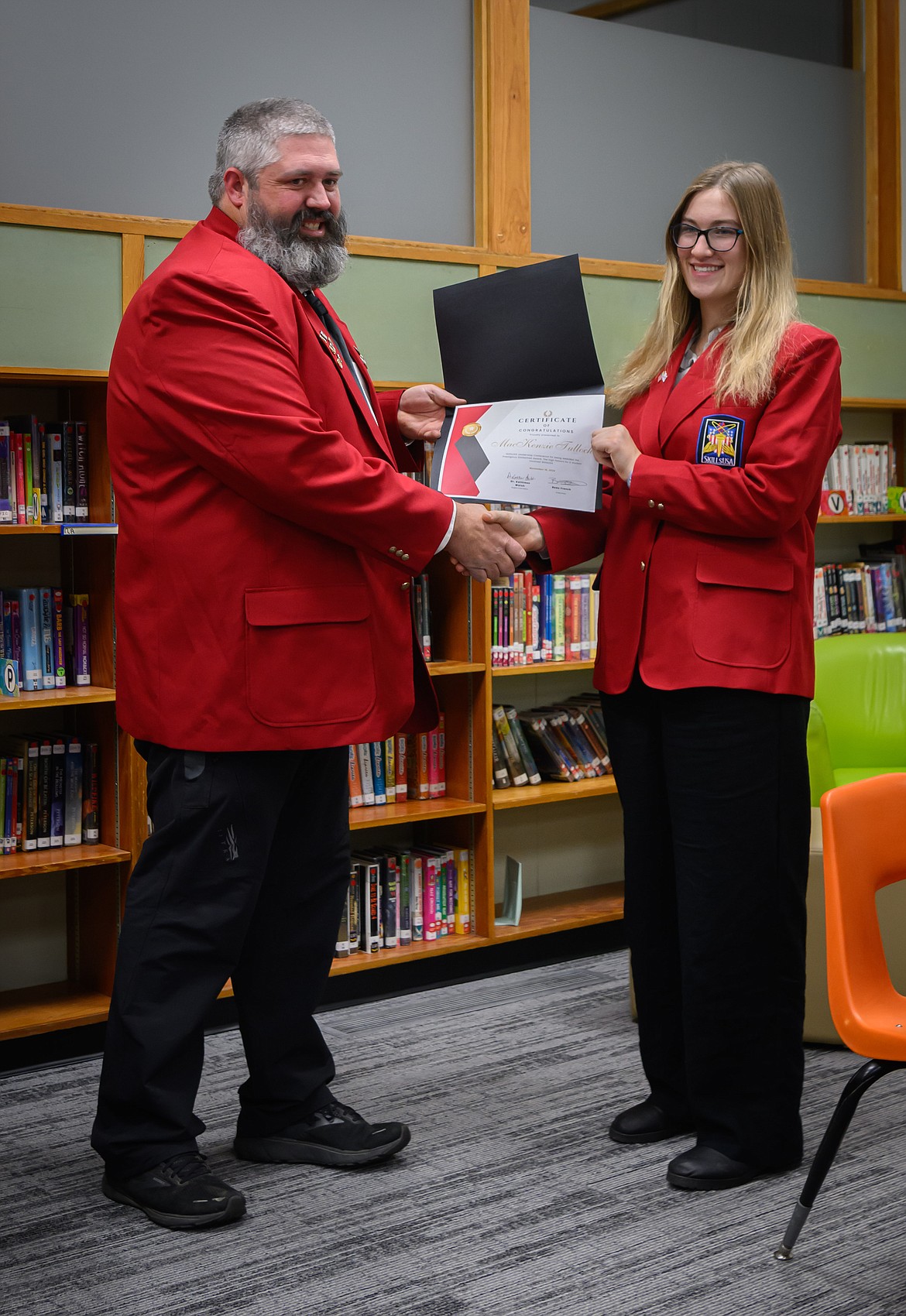 Shop teacher Kyle Mitchell gives Mackenzie Tulloch the SkillsUSA Stateman Award. (Tracy Scott/Valley Press)