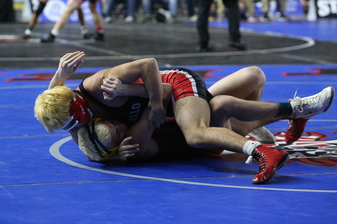 Othello senior Jeremiah Flores, top, wrestles at the 2024 Mat Classic in Tacoma in February. Flores placed fourth in the 150-pound class last season.