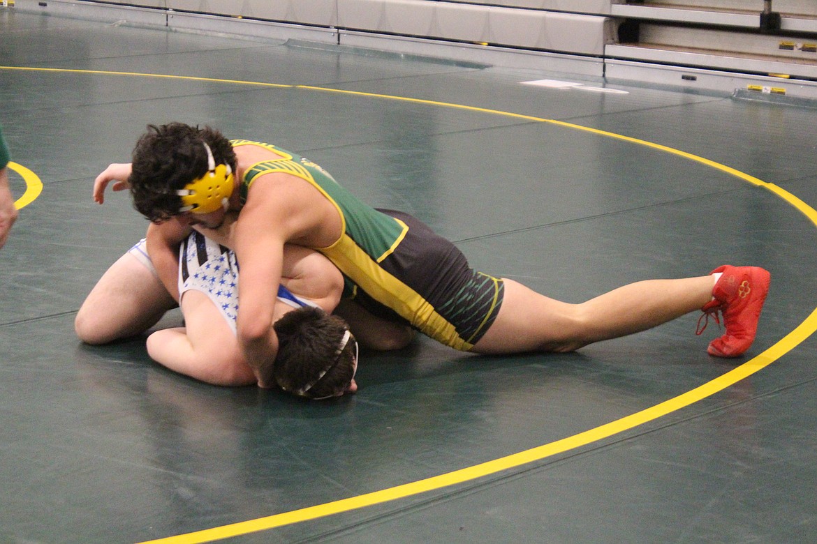 Alejandro Barajas, in green, was one of three Quincy wrestlers to qualify for the 2024 Mat Classic.