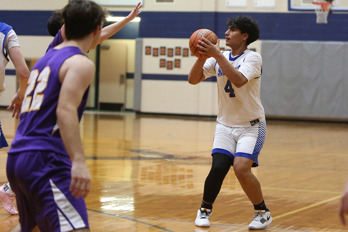 Soap Lake senior Jairo Lopez, right, attempts a three-pointer during the 2023-24 season.