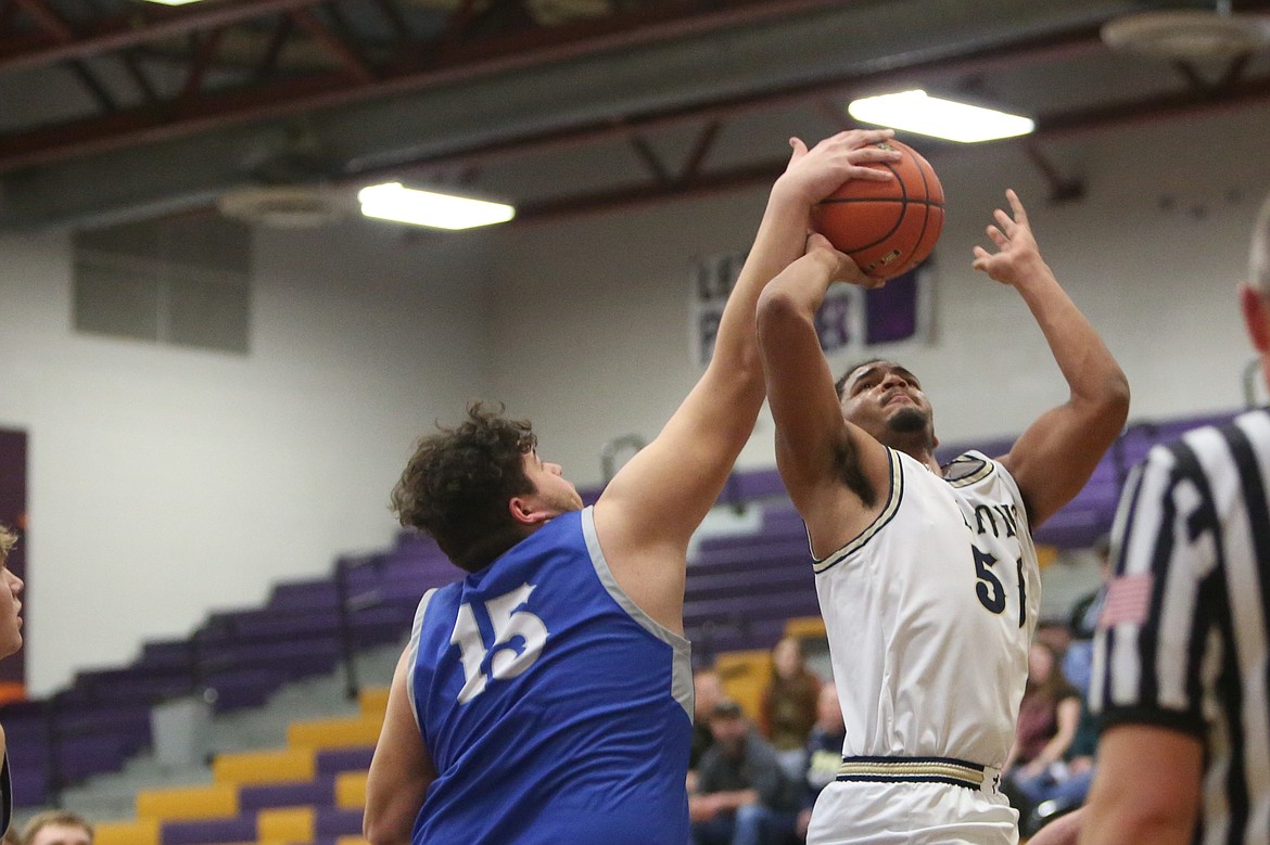 Soap Lake senior Jesse Morales (15) blocks a shot during the Central Washington B district championship game in Wenatchee. The Eagles finished second in both league and districts last season, qualifying for the 1B Boys State Basketball Tournament.